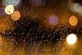 Rain falls on the window and night lightsÃÂ  in light bokeh, city life at night in the rainy season abstract background, a drop of Royalty Free Stock Photo